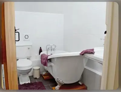 a bathroom with a toilet and a bath tub at Awel Yr Mynydd in Ystrad Meurig
