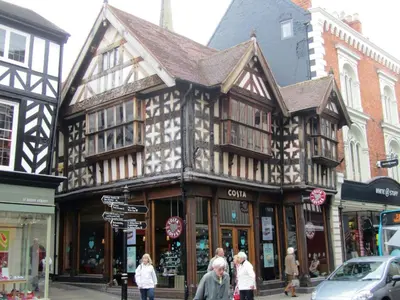 a building on a street with people walking in front of it at Ludwick Apartment in Shrewsbury