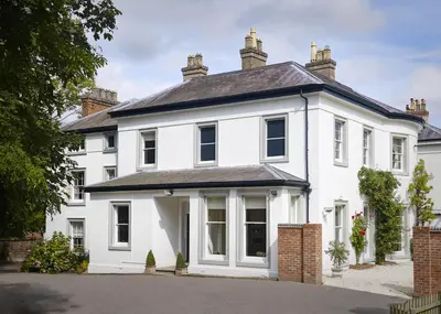 a white house with a black roof at Ludwick Apartment in Shrewsbury