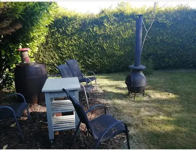 a group of chairs and a stove in a yard at Spyder Ranch in Trawsfynydd