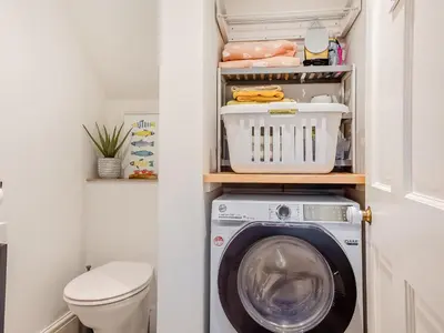a laundry room with a washer and dryer at Isfryn in Llanbedr