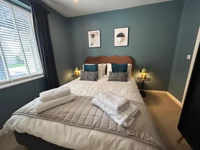 a bedroom with a bed with towels on it at Luxury 2 bedroom town apartment in Aberystwyth