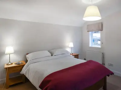 a bedroom with a large bed with two night stands at Sheldon Cottage in Bishops Castle
