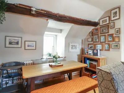 a living room with a table and a couch at Top Cottage Barmouth in Barmouth