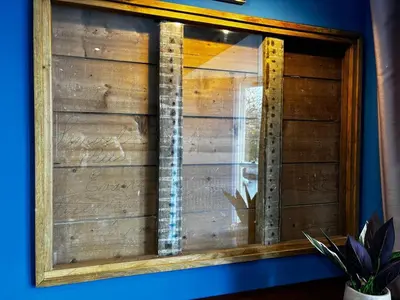 a window in a room with a wooden wall at Stunning fully refurbished house in New Quay
