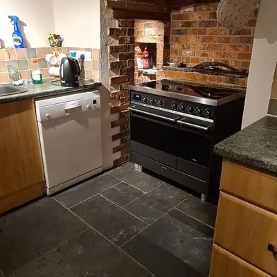 a kitchen with a black and white stove top oven at Character cottage with spectacular views in Church Stoke