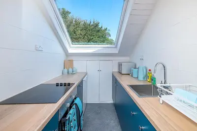 a kitchen with a sink and a skylight at Aberdovey Sea View Apartment in Aberdyfi