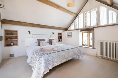 a bedroom with a large bed in a attic at Welsh Border Escape- Perfect for families & groups in Clyro