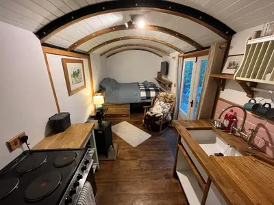 a kitchen and living room in a tiny house at the railway carraige in Three Cocks Junction