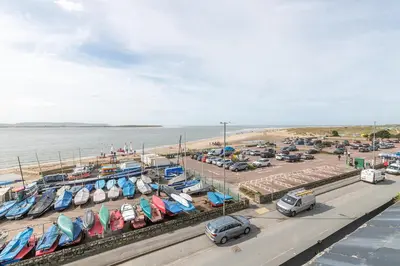 a parking lot with many boats in a harbor at Beach Front flat in Aberdovey in Aberdyfi
