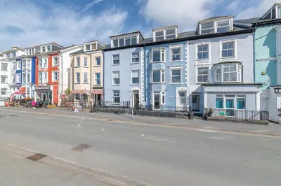 a row of colorful houses on a city street at Beach Front flat in Aberdovey in Aberdyfi