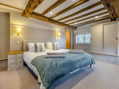 a bedroom with a large bed with two pillows on it at The Farmhouse - Uk48653 in Church Stretton