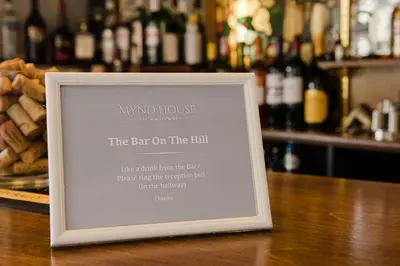 a sign sitting on top of a bar with food at Mynd House in Church Stretton