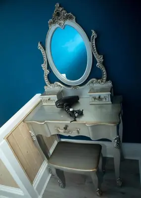 a dressing table with a mirror and a chair at The House of Gnarrr in Machynlleth