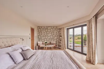 a bedroom with a bed and a large window at Upper Tumble Cottage in Montgomery