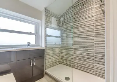 a glass shower in a bathroom with a window at 2 Bed in Llanfair oc-a30451 in Llanfair