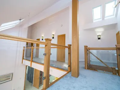 a staircase in a house with glass and wood at Modern 4-Bed Home Spacious & Comfortable - Pass the Keys in Pontesbury
