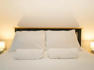 a bed with two white pillows and two lamps at Modern 4-Bed Home Spacious & Comfortable - Pass the Keys in Pontesbury