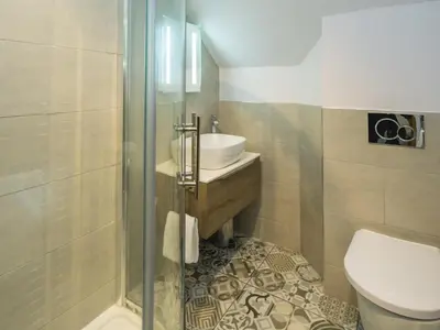 a bathroom with a shower and a sink and a toilet at Modern 4-Bed Home Spacious & Comfortable - Pass the Keys in Pontesbury