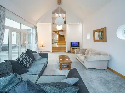 a living room with a couch and a table at Modern 4-Bed Home Spacious & Comfortable - Pass the Keys in Pontesbury