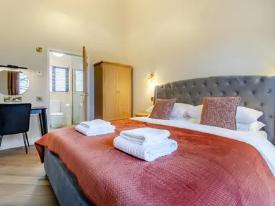 a bedroom with a large bed with towels on it at Root - Uk47733 in Mochdre