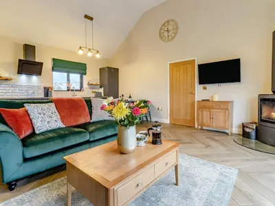 a living room with a green couch and a table at Root - Uk47733 in Mochdre