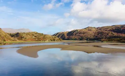 a large body of water with mountains in the background at Bryn Teg Barn in Dyffryn