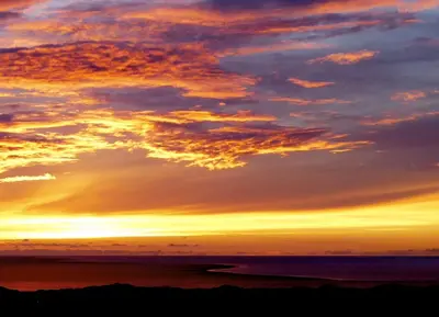 a sunset over the ocean with the sky at Bryn Teg Barn in Dyffryn