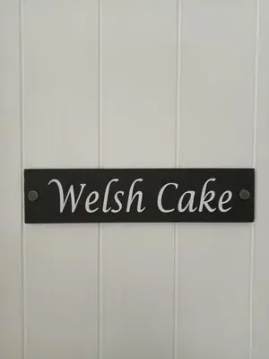 a sign that says welch cake on a wall at The Pantry in Erwood