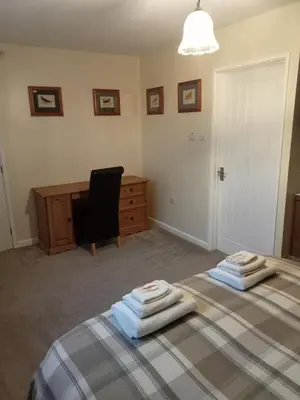 a bedroom with two beds with towels on top of them at The Pantry in Erwood