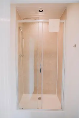 a shower with a glass door in a bathroom at The Pantry in Erwood
