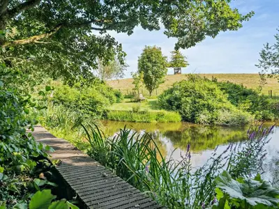 a garden path next to a river with trees at 2 Bed in Kington oc-92986 in Lyonshall