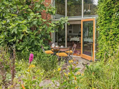 a patio with a table and chairs in a garden at 2 Bed in Kington oc-92986 in Lyonshall
