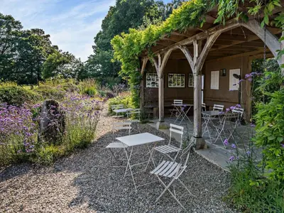a group of chairs and tables in a garden at 2 Bed in Kington oc-92986 in Lyonshall