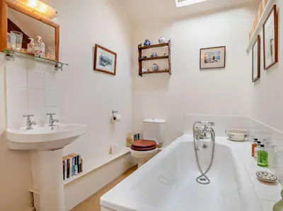 a bathroom with a sink and a tub and a toilet at 2 Bed in Kington oc-92986 in Lyonshall
