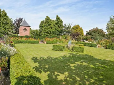 a garden with a clock tower in the background at 2 Bed in Kington oc-92986 in Lyonshall