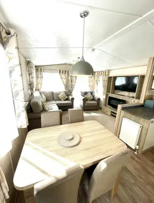 a dining room and living room in an rv at Gold Standard Luxury and Modern Static Caravan at Clarach Bay in Aberystwyth