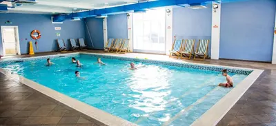 a group of people in a swimming pool at Gold Standard Luxury and Modern Static Caravan at Clarach Bay in Aberystwyth