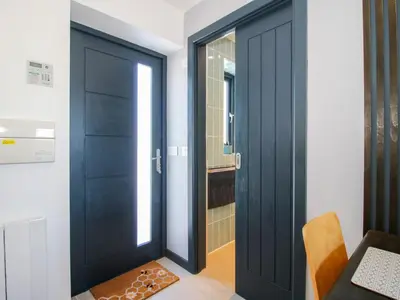 a black door in a room with a mirror at Stiper View Barn 1 in Shrewsbury