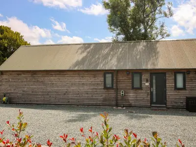 a small wooden building with a metal roof at Stiper View Barn 1 in Shrewsbury