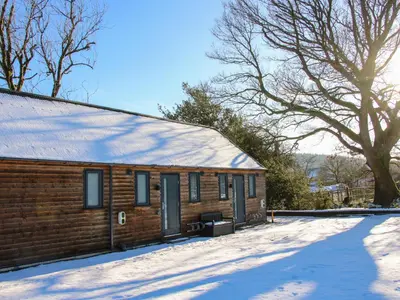 a log cabin with snow on the roof at Stiper View Barn 2 in Shrewsbury
