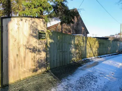 a fence with a sign on it next to a street at Stiper View Barn 2 in Shrewsbury