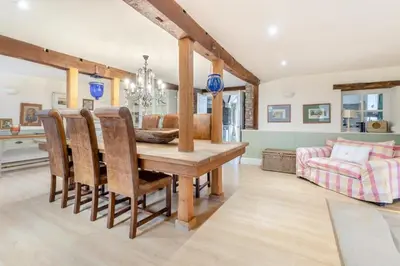 a dining room with a table and a couch at 6 Bed in Llanfilo oc-e30630 in Llandefalle