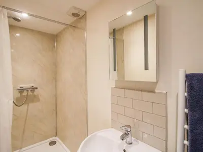 a bathroom with a sink and a shower at Millstone Cottages - Granary Cottage in Shrewsbury