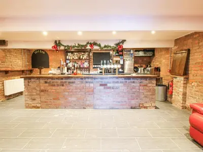 a bar in a room with a brick wall at Millstone Cottages - Middle Cottage in Shrewsbury