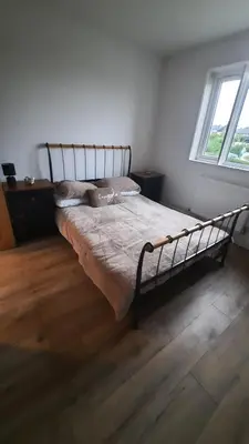 a bedroom with a bed in a room with a window at Conkers Cottage in Forden