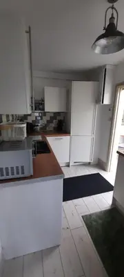 a kitchen with white cabinets and a counter top at Conkers Cottage in Forden