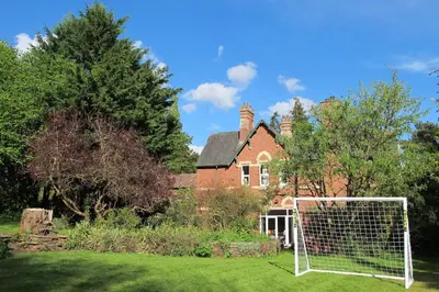 a house with a soccer goal in front of it at The Old Vicarage with hot-tub & sauna in Vowchurch