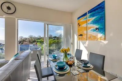 a dining room with a table and a large window at 2 Bed in Aberdovey oc-n30627 in Aberdyfi