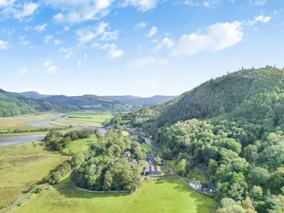 an aerial view of a valley with trees and a river at 2 Bed in Penmaenpool oc-m30050 in Arthog